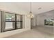 Inviting living room with large windows, a ceiling fan, and an open layout at 314 Pembroke Ln # 189, Venice, FL 34293