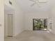 Open living space featuring neutral walls, carpet, a ceiling fan, and sliders to the outdoors at 314 Pembroke Ln # 189, Venice, FL 34293