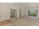Bright and spacious living room with a ceiling fan and sliding glass doors at 314 Pembroke Ln # 189, Venice, FL 34293