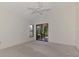 The primary bedroom features a ceiling fan, a window, and sliding glass doors that lead to a private screened-in lanai at 314 Pembroke Ln # 189, Venice, FL 34293