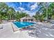 Large community swimming pool surrounded by lounge chairs and tables for outdoor relaxation and enjoyment at 314 Pembroke Ln # 189, Venice, FL 34293