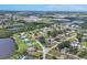 Expansive aerial view showcasing the neighborhood's layout, with houses near a pond and the distant cityscape at 322 Linden Dr, Ellenton, FL 34222