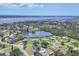 Wide aerial view showing neighborhood homes around a pond and scenic waterfront views from elevated perspective at 322 Linden Dr, Ellenton, FL 34222