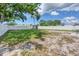 Expansive backyard with a shed, partially-grassed area and a full white vinyl fence at 322 Linden Dr, Ellenton, FL 34222