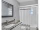 Updated bathroom boasts granite countertop, framed mirror, and shower-tub combo at 322 Linden Dr, Ellenton, FL 34222