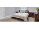 Serene bedroom with soft carpet, neutral walls, and a cozy queen-sized bed with decorative pillows at 322 Linden Dr, Ellenton, FL 34222