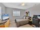 Neutral bedroom features a ceiling fan, modern window blinds, gaming desk, and a wall-mounted TV at 322 Linden Dr, Ellenton, FL 34222