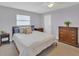 Comfortable bedroom features neutral walls, carpet, and wood furniture at 322 Linden Dr, Ellenton, FL 34222