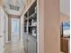 Inviting hallway with built-in shelving leading to a bathroom, enhancing the home's functionality and style at 322 Linden Dr, Ellenton, FL 34222