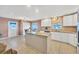 Bright, open kitchen featuring an island, neutral countertops, and ample cabinet space for efficient cooking at 322 Linden Dr, Ellenton, FL 34222