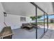 Covered patio space with outdoor seating and a view of the expansive fenced backyard at 322 Linden Dr, Ellenton, FL 34222