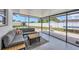 Spacious screened patio featuring a gray couch and backyard views for relaxing and entertaining at 322 Linden Dr, Ellenton, FL 34222