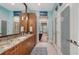 Bathroom featuring dual sinks with an eye catching vanity and a large well-lit mirror at 3272 Bayou Rd, Longboat Key, FL 34228