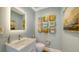 Powder room featuring modern fixtures, stylish mirror, and artwork at 3272 Bayou Rd, Longboat Key, FL 34228