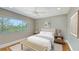 Serene bedroom with large window, neutral tones, wood floors, and simple decor at 3272 Bayou Rd, Longboat Key, FL 34228