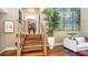 Elegant entryway with wooden staircase, large artwork, and stylish decor at 3272 Bayou Rd, Longboat Key, FL 34228