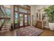 Home with a grand foyer featuring hardwood floors, a staircase, and a large window at 3272 Bayou Rd, Longboat Key, FL 34228