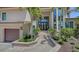 Home with lovely landscaping, two-car garage, and a stone walkway to the front door at 3272 Bayou Rd, Longboat Key, FL 34228