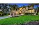Beautifully landscaped front yard with green grass and a home with two-car garage at 3272 Bayou Rd, Longboat Key, FL 34228