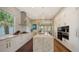 Bright kitchen featuring an island, stainless steel appliances, and ample storage in sleek white cabinetry at 3272 Bayou Rd, Longboat Key, FL 34228