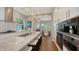A kitchen with a marble topped island, stainless steel appliances, and room for seating at 3272 Bayou Rd, Longboat Key, FL 34228