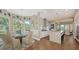 Open kitchen and breakfast nook with hardwood floors, island seating, and bright natural light at 3272 Bayou Rd, Longboat Key, FL 34228