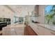 A modern kitchen features stainless steel appliances, marble countertops, and lots of natural light at 3272 Bayou Rd, Longboat Key, FL 34228