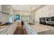 A kitchen with a marble topped island, stainless steel appliances, and modern backsplash at 3272 Bayou Rd, Longboat Key, FL 34228