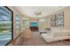 Spacious living room with waterfront views, hardwood floors, and access to an outdoor pool area at 3272 Bayou Rd, Longboat Key, FL 34228