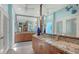 Stylish main bathroom with a large vanity mirror, dual sinks, and wood cabinets at 3272 Bayou Rd, Longboat Key, FL 34228