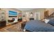 Main bedroom with stylish desk, shelving, and a vibrant beach scene hanging above it at 3272 Bayou Rd, Longboat Key, FL 34228