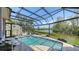 Inviting screened-in pool area with sun loungers, seating, and lush landscaping at 3272 Bayou Rd, Longboat Key, FL 34228