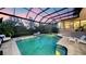 Inviting screened-in pool with built-in lights and lounge chairs enhances backyard enjoyment at 3272 Bayou Rd, Longboat Key, FL 34228