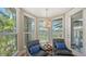 Comfortable sitting area featuring bay window views, stylish chairs, and neutral walls at 3272 Bayou Rd, Longboat Key, FL 34228