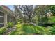 Serene backyard with lush greenery, a pond, and a screened lanai, perfect for relaxation at 3623 Square West Ln # 5, Sarasota, FL 34238