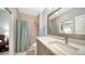 Bathroom featuring a vanity with a modern sink, mirror, and a shower with patterned curtain at 3623 Square West Ln # 5, Sarasota, FL 34238