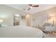 Comfortable bedroom with tile floors, a plush chair, and access to an en-suite bath at 3623 Square West Ln # 5, Sarasota, FL 34238