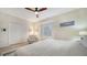 Bright bedroom with neutral colors, a ceiling fan, and an accent chair near the window at 3623 Square West Ln # 5, Sarasota, FL 34238