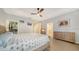 Spacious bedroom with neutral walls, tray ceiling, and access to closet, bedroom, and ensuite at 3623 Square West Ln # 5, Sarasota, FL 34238