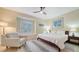 Bedroom with a large window with shutters, tiled floors, and a comfortable sitting area at 3623 Square West Ln # 5, Sarasota, FL 34238