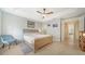 Bright bedroom with neutral walls, tray ceiling, tiled floors, and an adjoining hallway at 3623 Square West Ln # 5, Sarasota, FL 34238