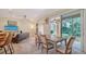 Dining room overlooking screened porch and lush greenery at 3623 Square West Ln # 5, Sarasota, FL 34238