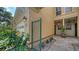 Close-up of the townhome entrance featuring a secure gate and well-maintained landscaping at 3623 Square West Ln # 5, Sarasota, FL 34238