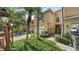 Attractive townhome with lush landscaping, a brick driveway, and gated front entrance at 3623 Square West Ln # 5, Sarasota, FL 34238