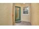 Elegant front door featuring glass detailing, next to a charming window at 3623 Square West Ln # 5, Sarasota, FL 34238