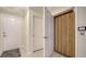 Bright hallway showcasing multiple doorways, including access to an elevator at 3623 Square West Ln # 5, Sarasota, FL 34238