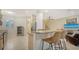 Kitchen with bar stool seating and a view into the living area at 3623 Square West Ln # 5, Sarasota, FL 34238