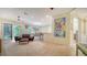 Spacious living room featuring tile floors, a ceiling fan, and access to a covered patio at 3623 Square West Ln # 5, Sarasota, FL 34238