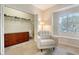 A cozy office space with a large window, dresser, chair, and organized closet at 3623 Square West Ln # 5, Sarasota, FL 34238