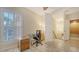 Office space featuring a desk, chair, cabinets, and a staircase with neutral colors at 3623 Square West Ln # 5, Sarasota, FL 34238